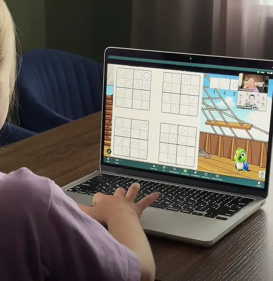 A girl completing an arrow maze in a logic lesson